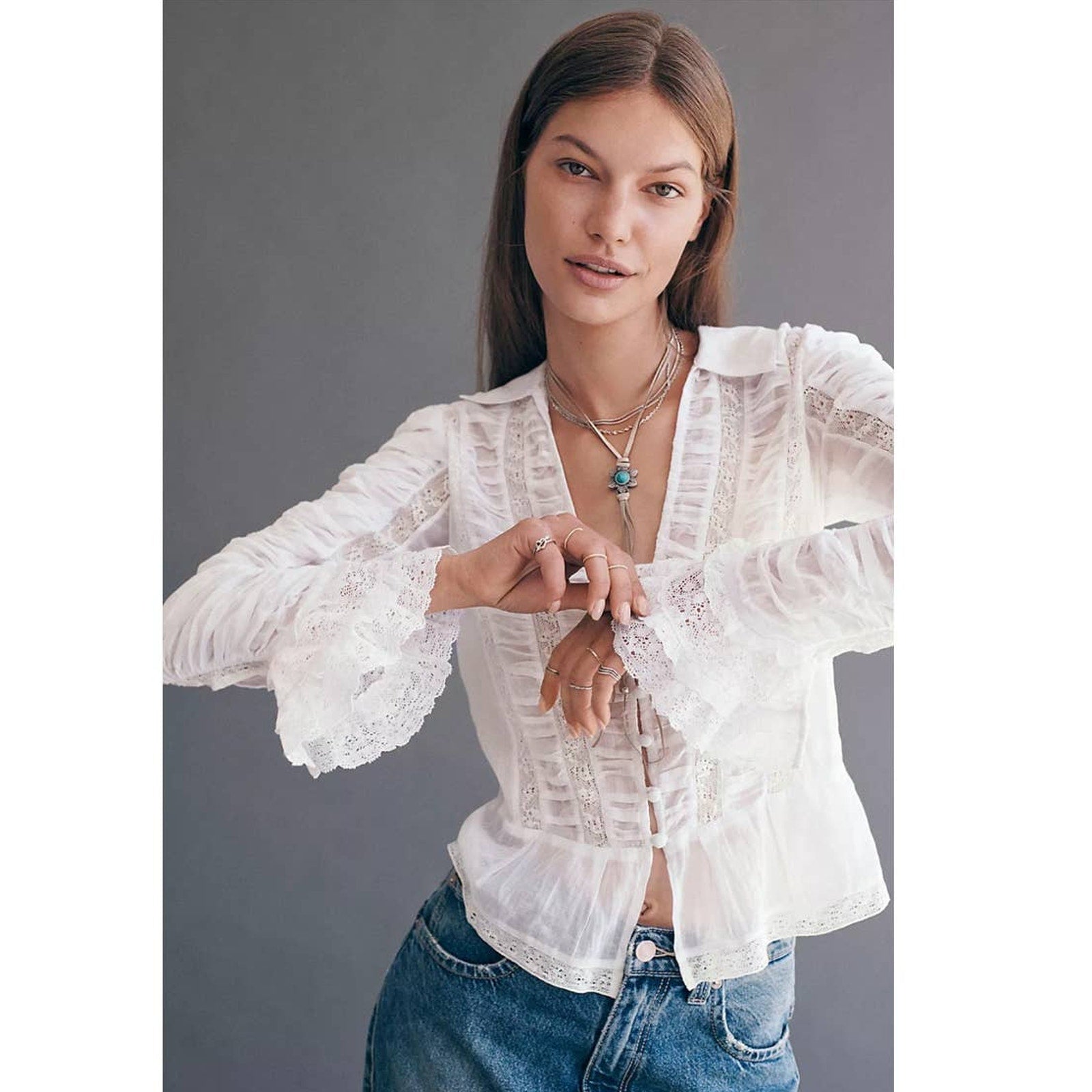 Ivory long-sleeve lace button blouse with ruffled placket and pintuck details
