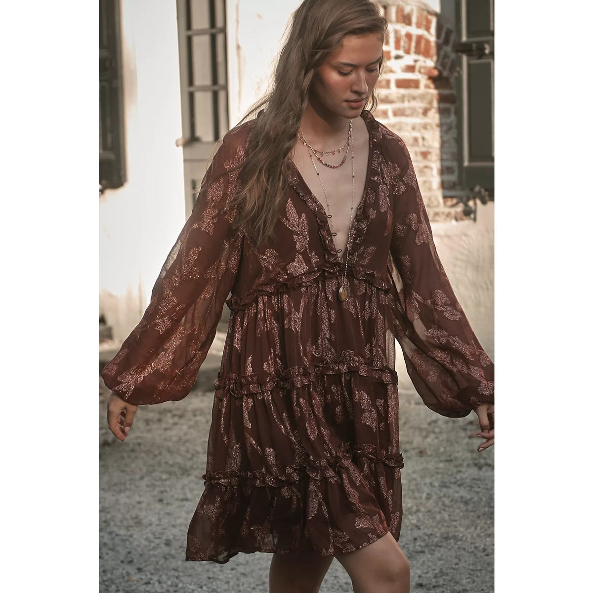 Long-sleeve tiered mini dress in dark plum with metallic floral print, ruffled hem