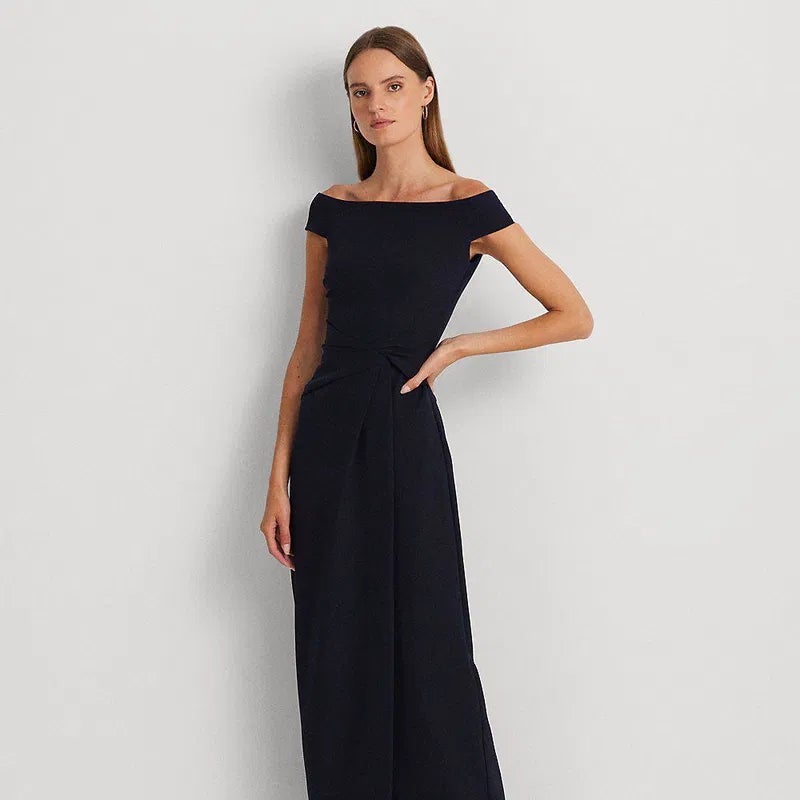 Navy off-shoulder crepe gown with wrap-like waist detail and long column skirt