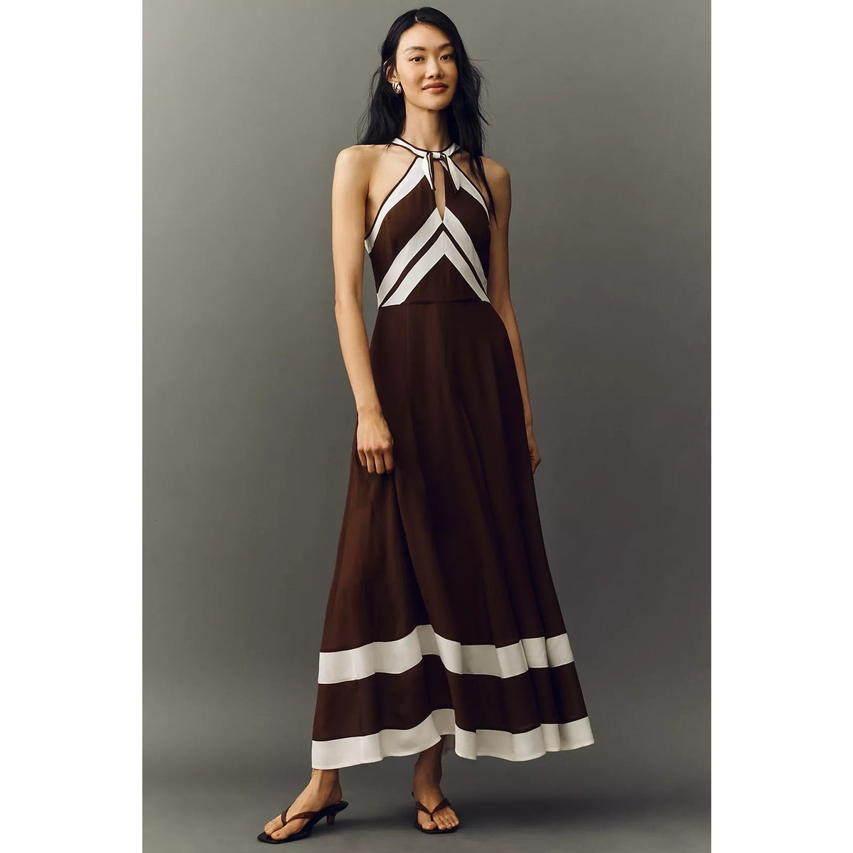 Brown halter maxi dress with geometric white stripes and sleeveless tie-neck detail