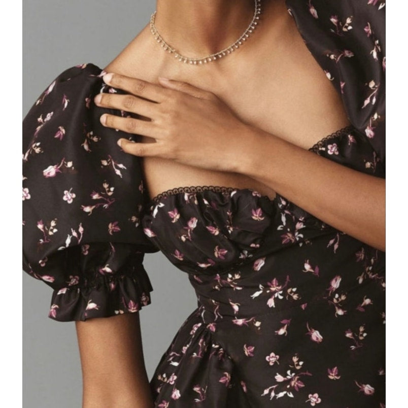 Floral mini dress bodice close-up with puff sleeves and square neckline