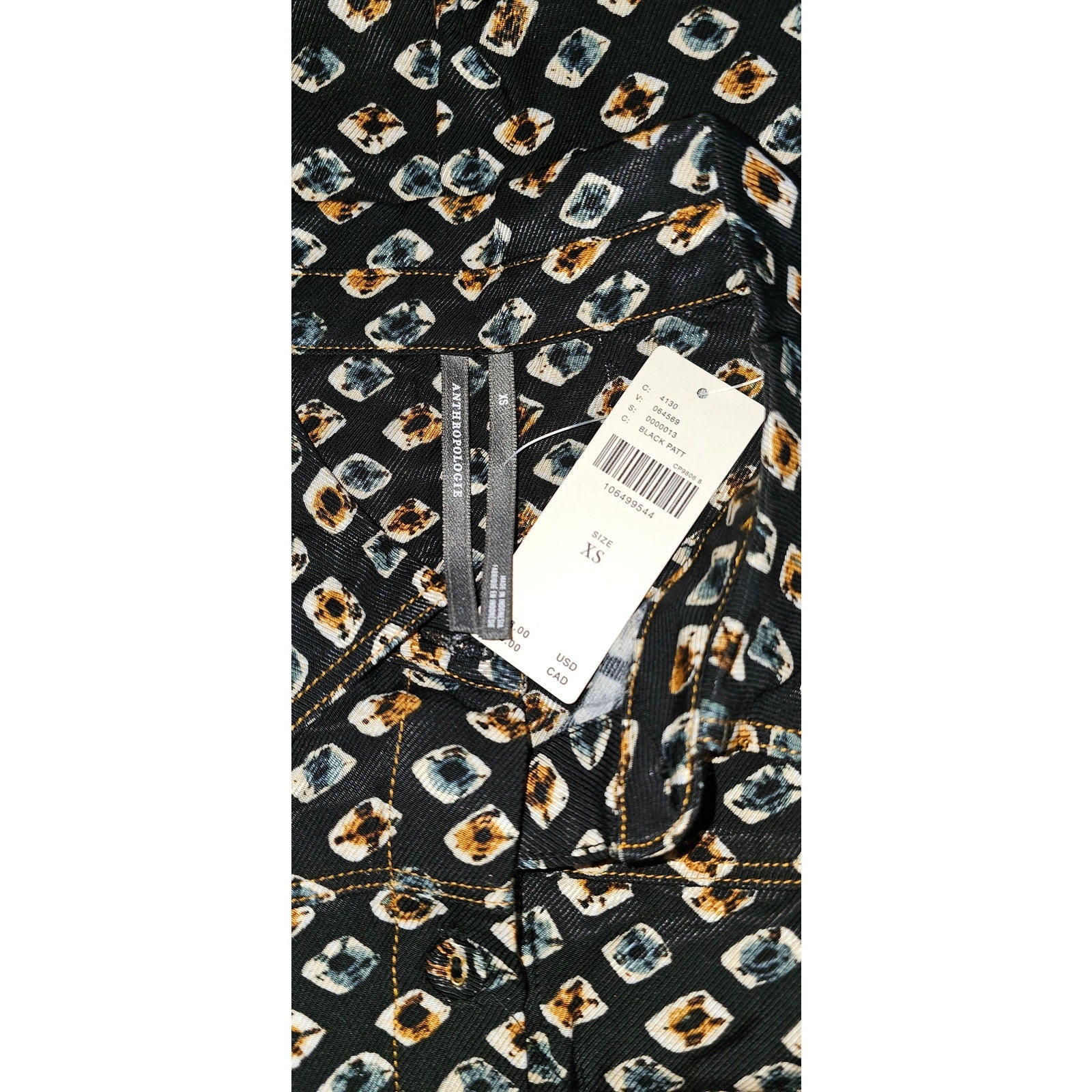 Black printed shirtdress fabric with multicolor motif and size tag
