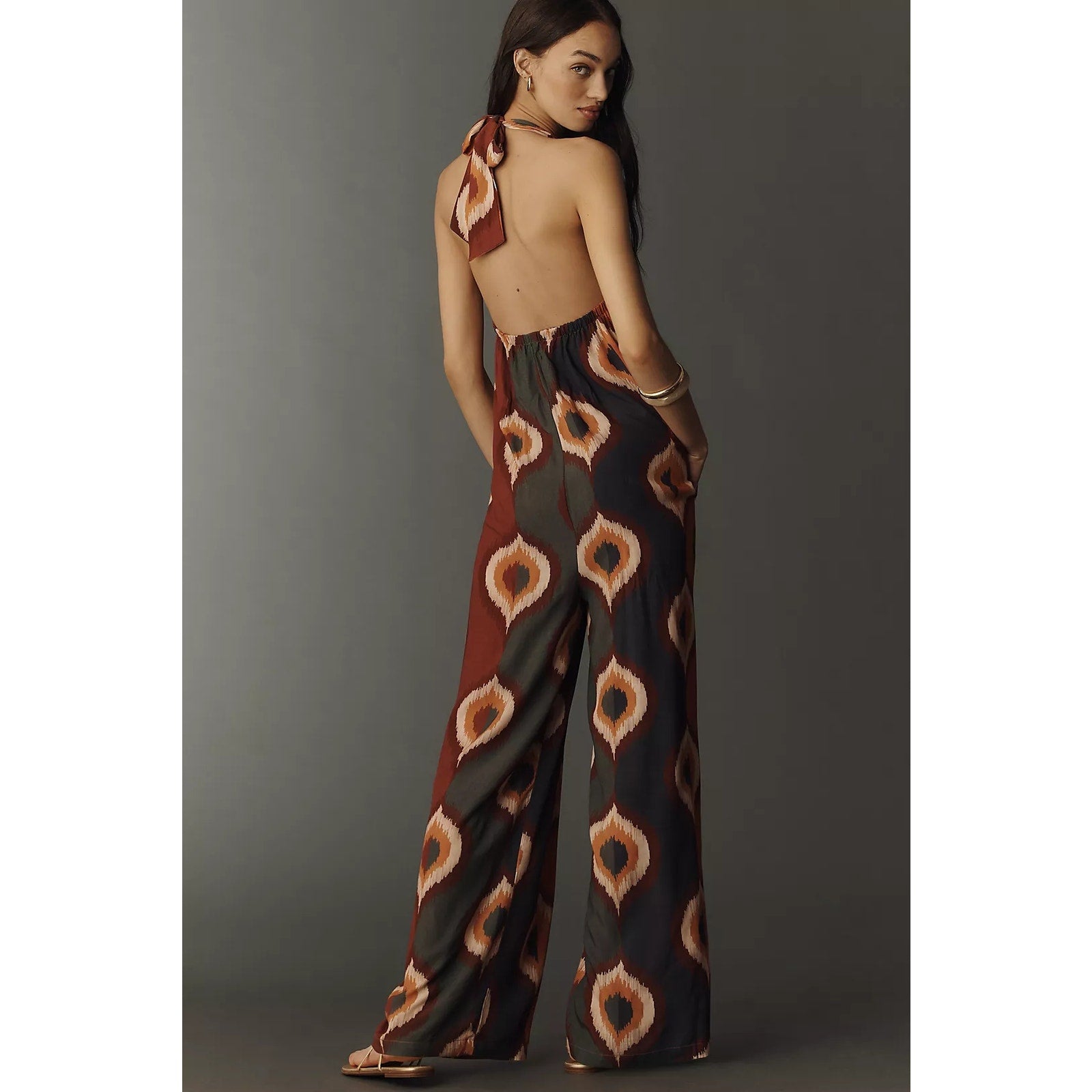 Backless halter jumpsuit with wide legs and orange-brown diamond pattern
