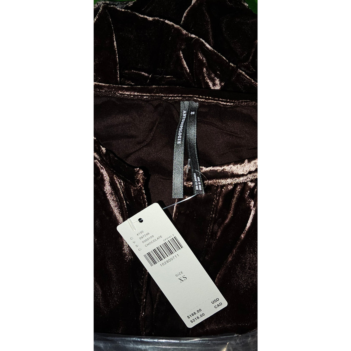 Chocolate velvet maxi dress fabric close-up with size tag attached