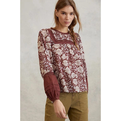 Burgundy lace blouse with white floral pattern and wide neckline yoke