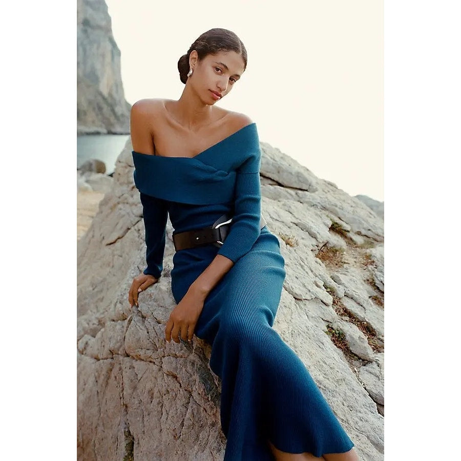 Off-shoulder blue sweater dress with fitted knit bodice and flared hem