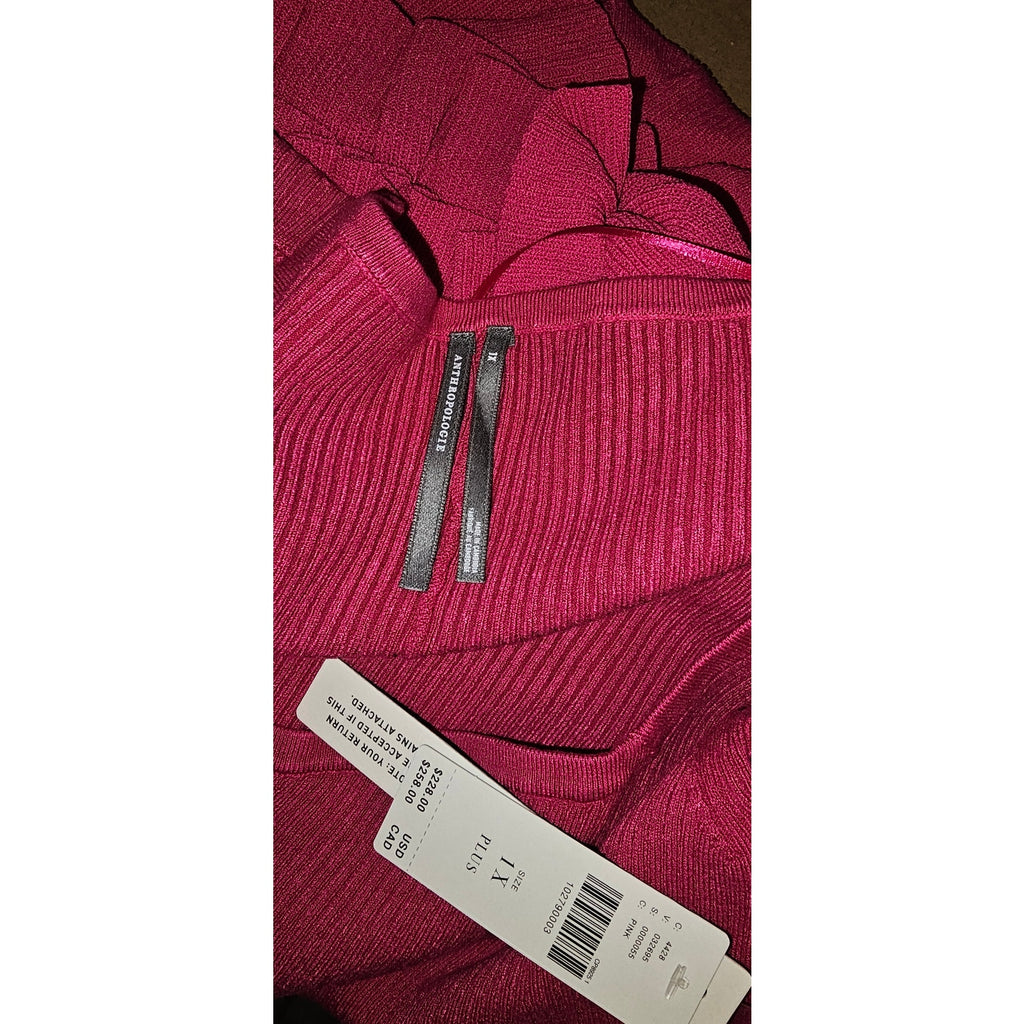 Pink ribbed-knit sweater dress fabric with trim detail and size/care label