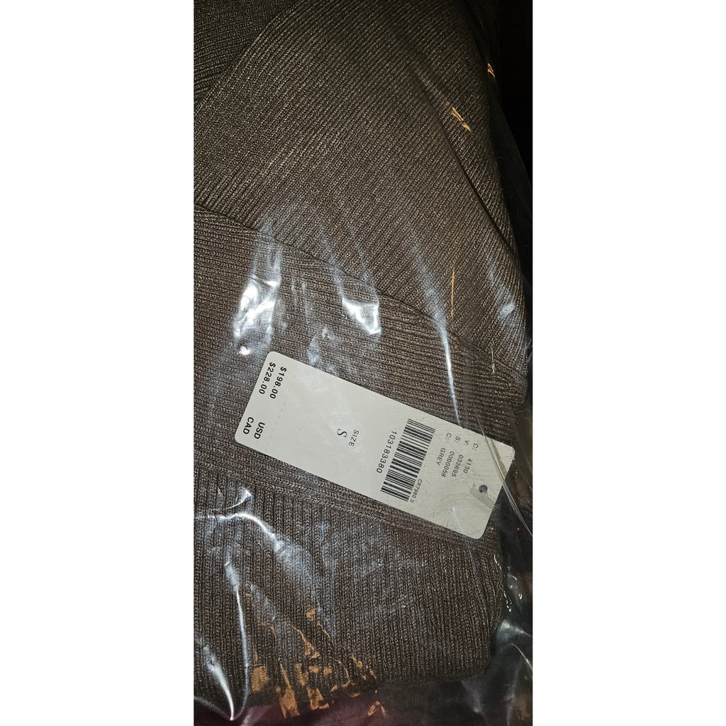 Gray knit sweater fabric close-up with barcode label in clear plastic