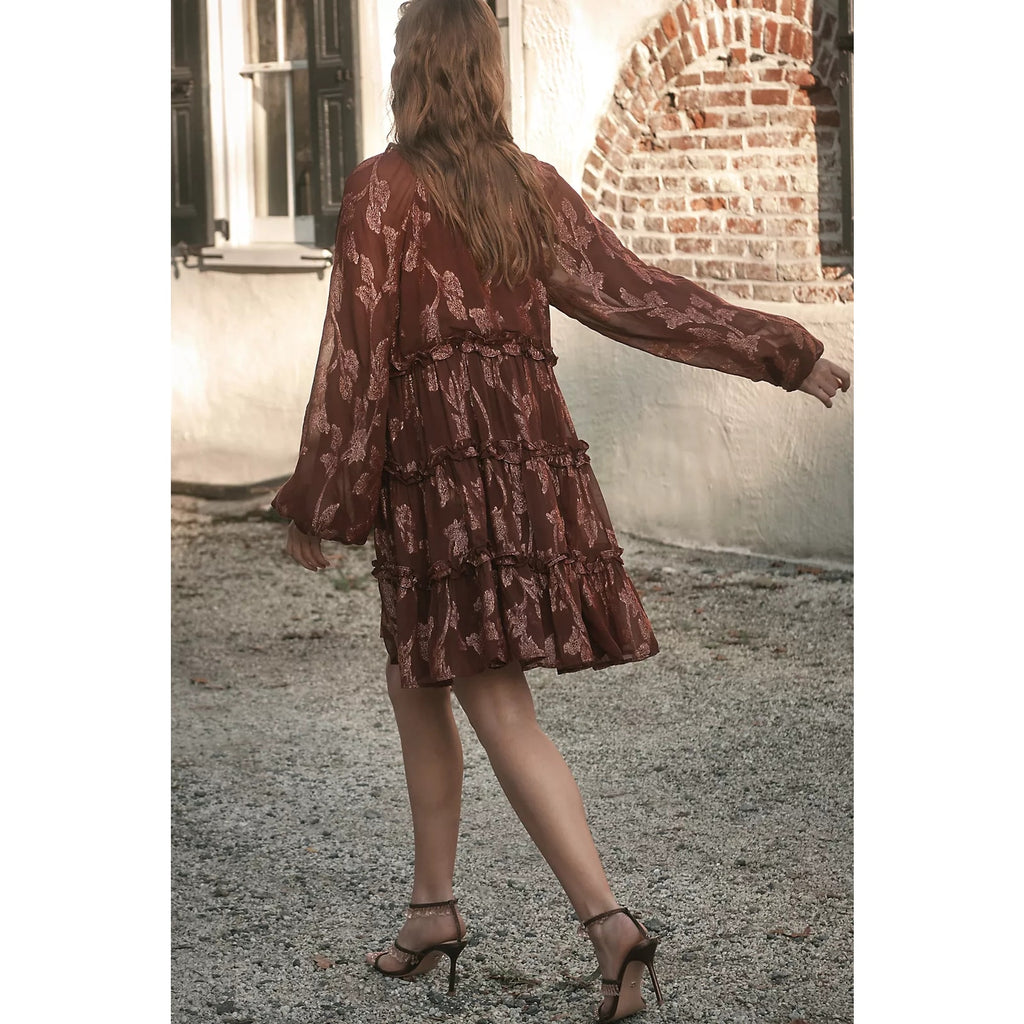Long-sleeve tiered metallic mini dress back view, dark plum-brown with tiered skirt