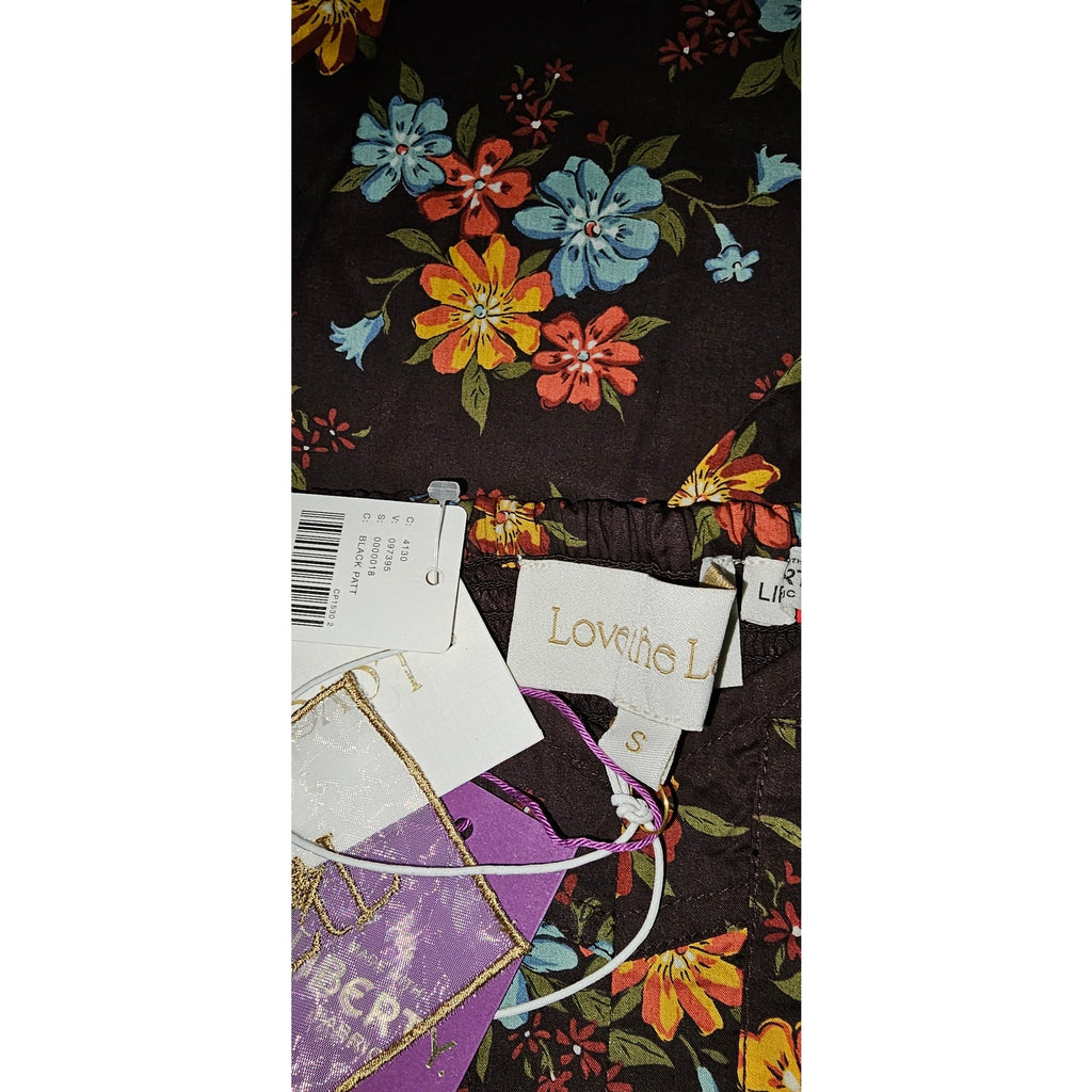 Floral print dress fabric with product tags and stitched hem detail