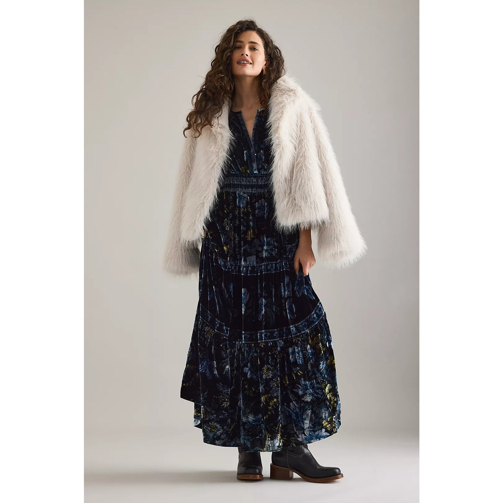 Dark blue velvet maxi dress with V-neck, short sleeves, and tiered ruffle skirt