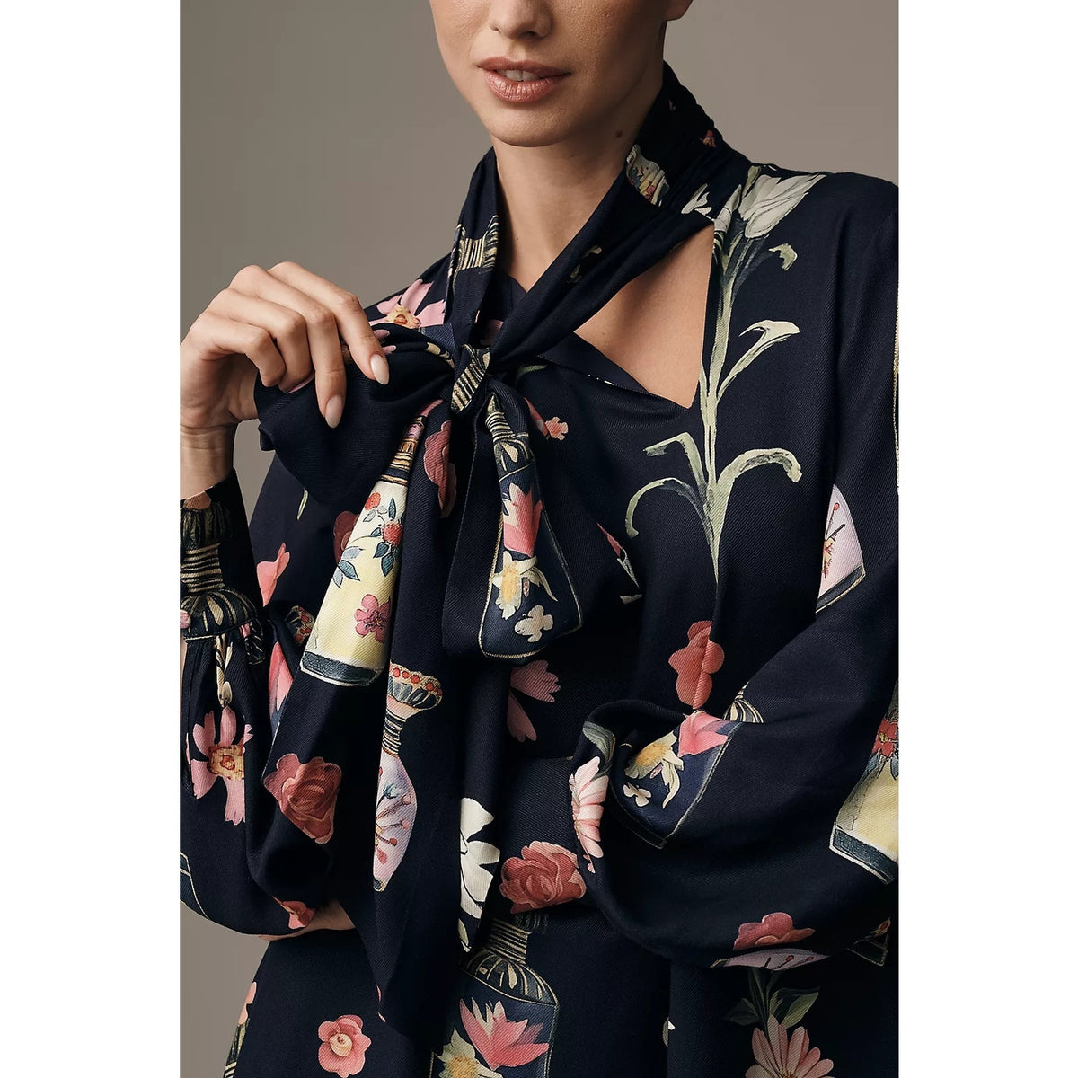 Navy tie-neck mini dress with floral print and long sleeves, bow at collar