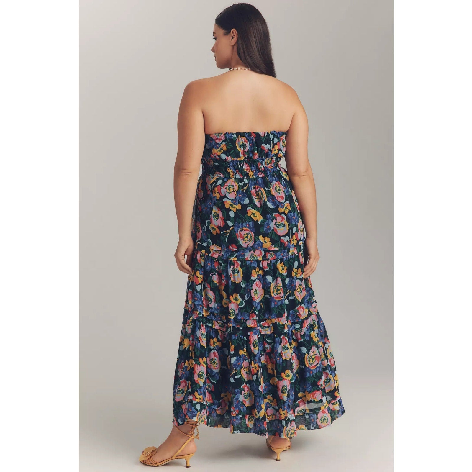 Strapless tiered maxi dress back view with colorful floral print and gathered waist