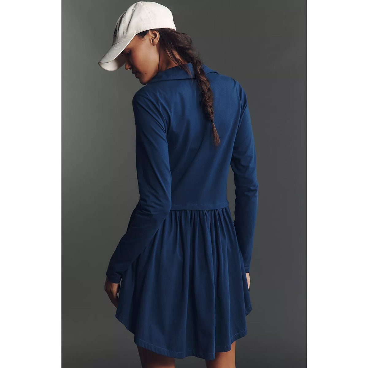 Back view of a navy long-sleeve mini dress with a gathered skirt