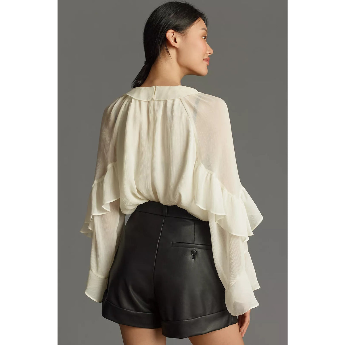 Black faux leather cuffed shorts with waistband and pleated leg opening