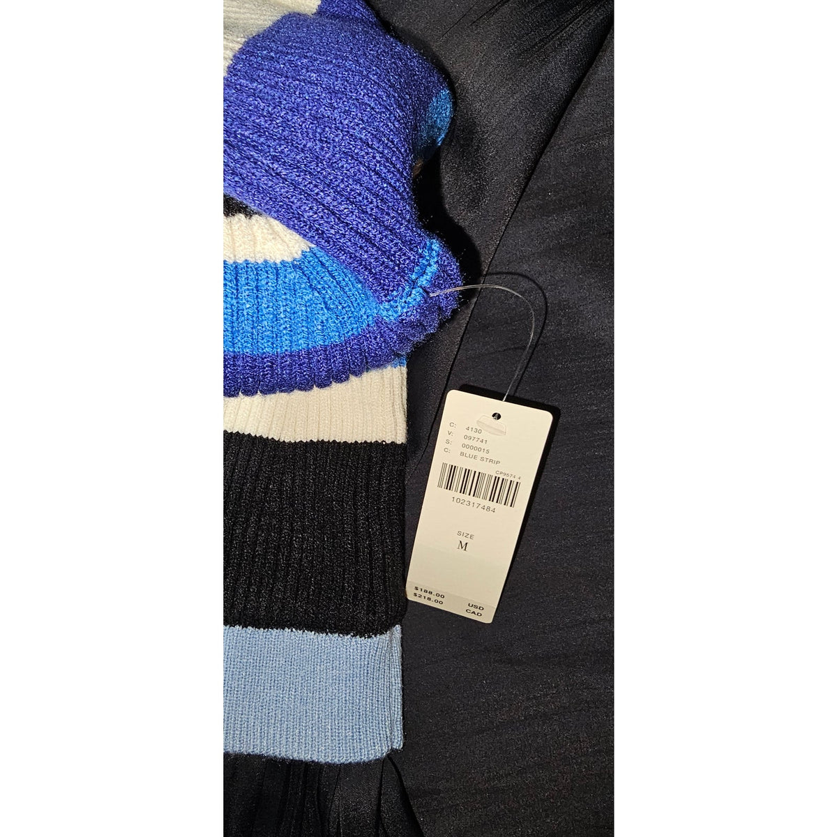 Twofer maxi dress detail: blue striped knit sleeve and hanging size tag