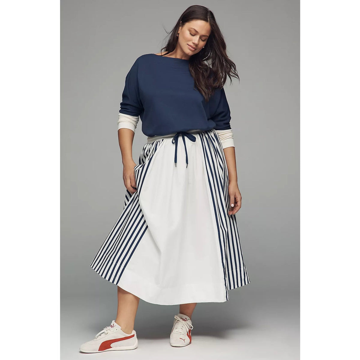 Navy and white maxi dress with long sleeves, drawstring waist, and striped skirt