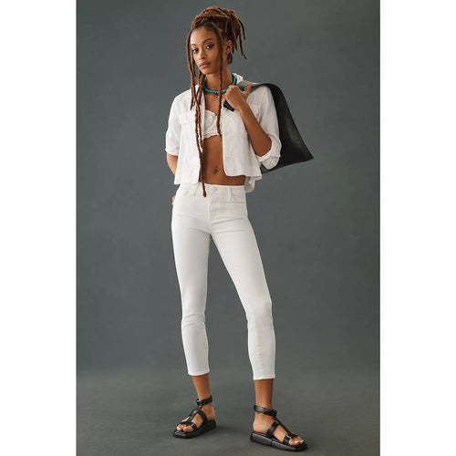 Crisp white high-rise skinny jeans, ankle-crop length with zip fly and belt loops