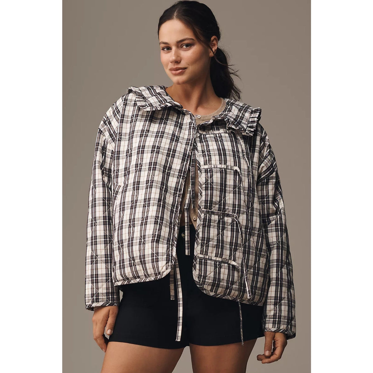 Plaid quilted jacket with ruffled collar, snap closure, and patch pockets