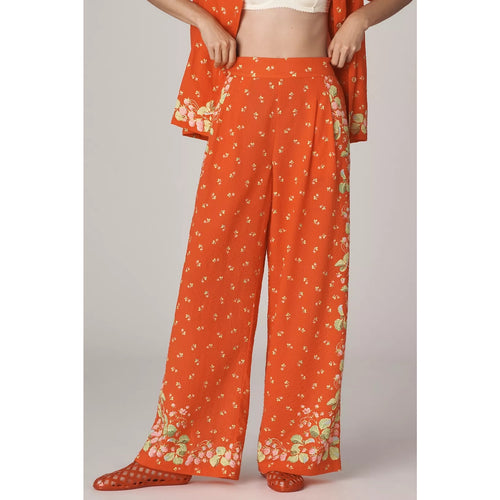 Orange high-rise wide-leg pants with gathered waist and floral border hem
