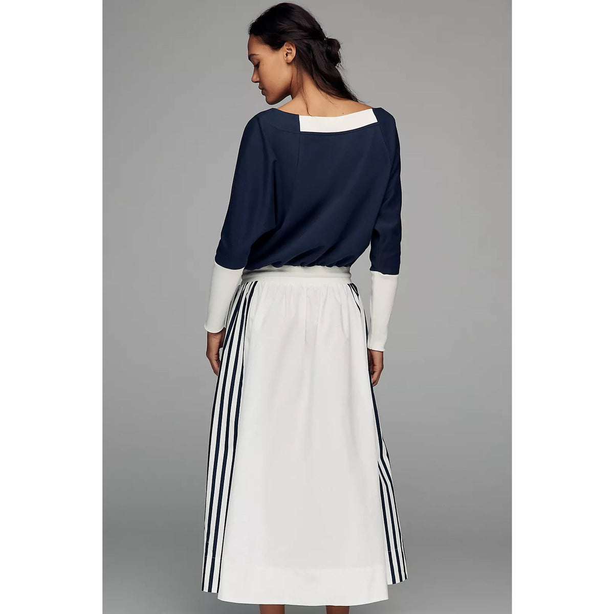 Maxi dress from back view: navy top with elbow sleeves and white striped skirt