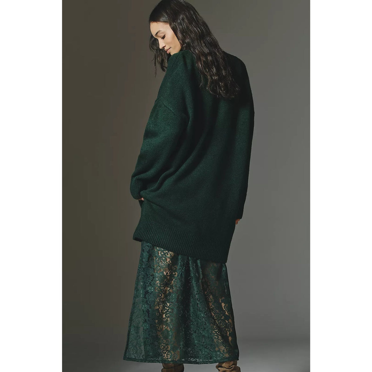 Back view of green sweater lace midi dress with a flowing lace skirt