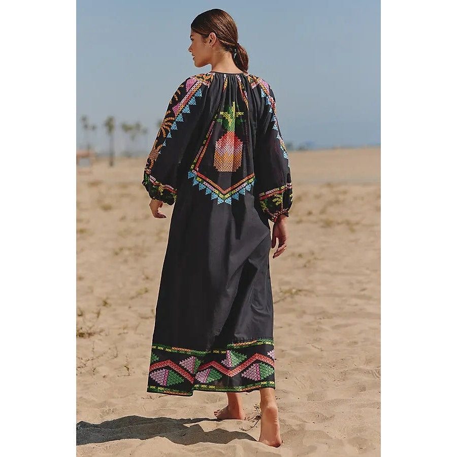 Black long-sleeve maxi dress with colorful yoke details and embroidered border hem