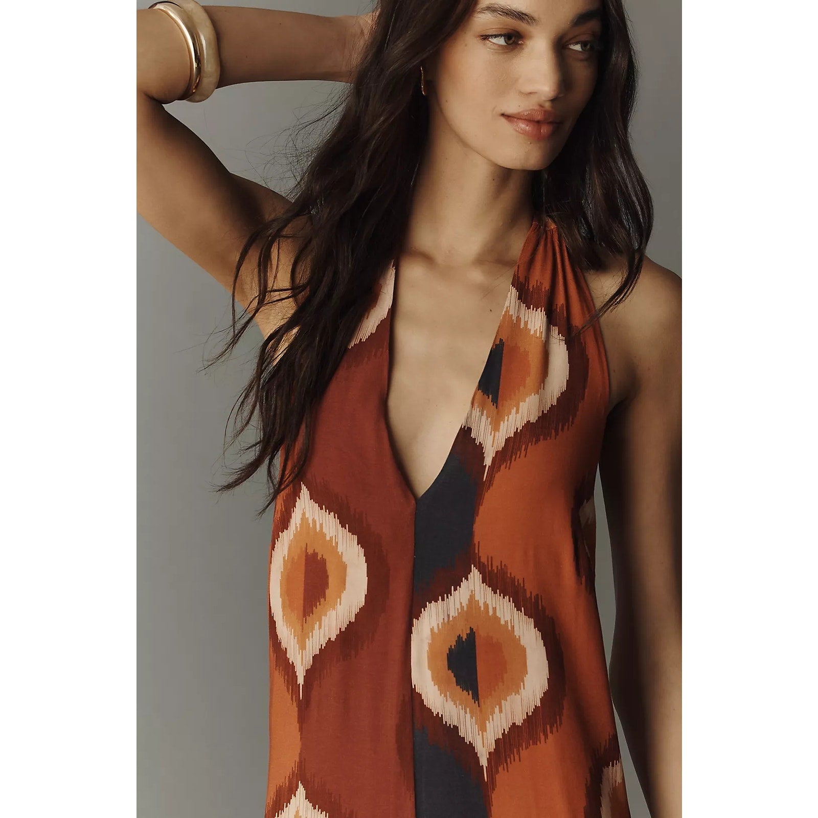 Halter-neck jumpsuit front with deep V and orange-brown ikat pattern