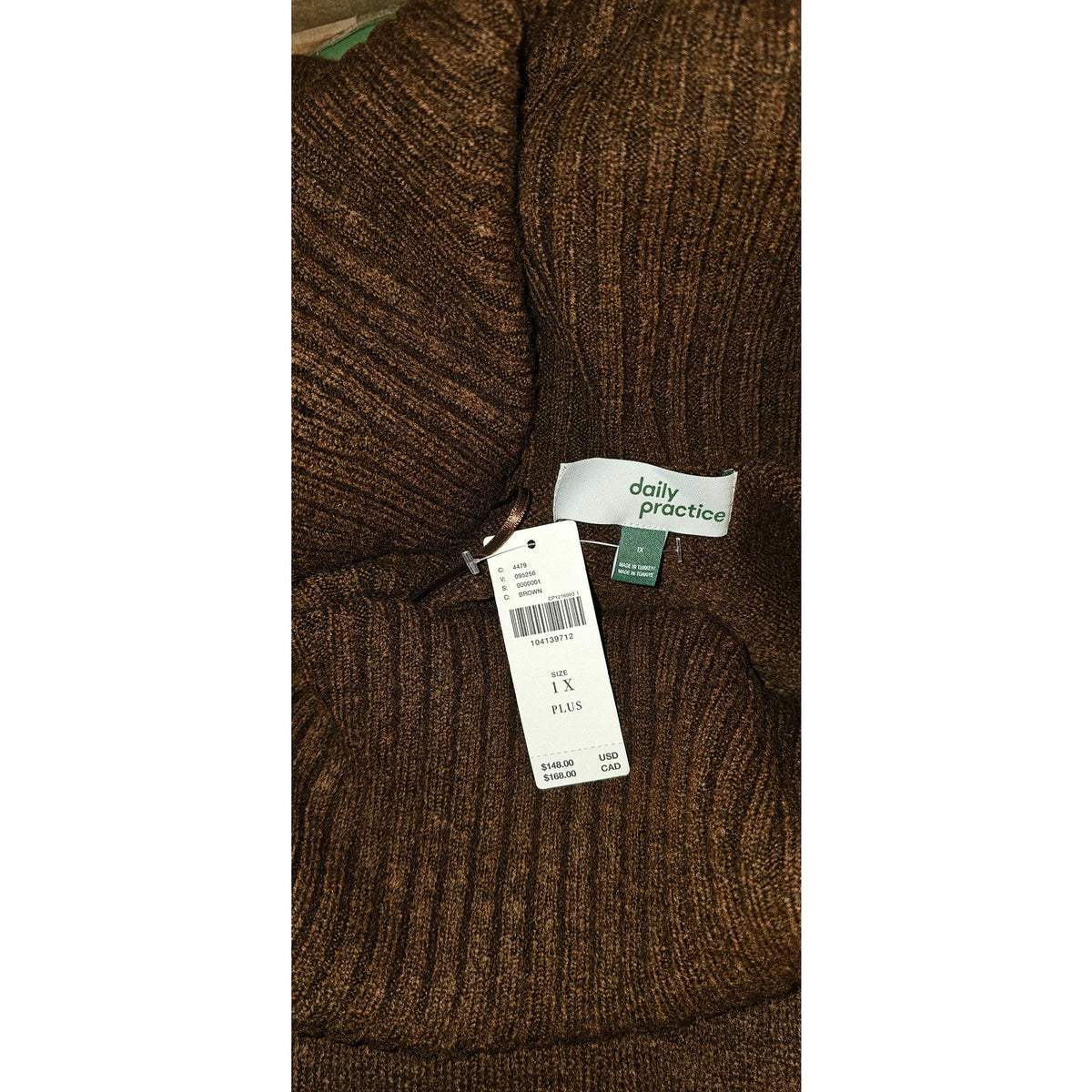Brown knit midi sweater dress closeup with ribbed texture and inside size label