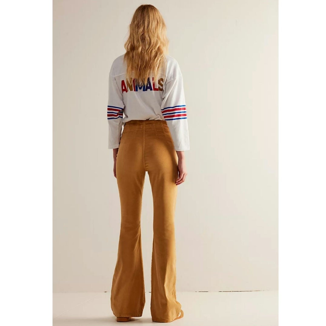Mustard cord flare jeans from back view with back yoke and wide hem