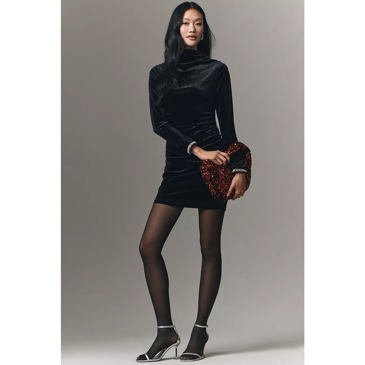 Black ruched cowl-neck mini dress with shiny finish and jeweled cuff details