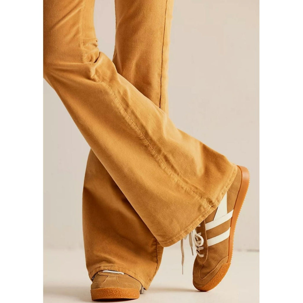 Mustard cord flare jeans close-up of hem and flared leg opening