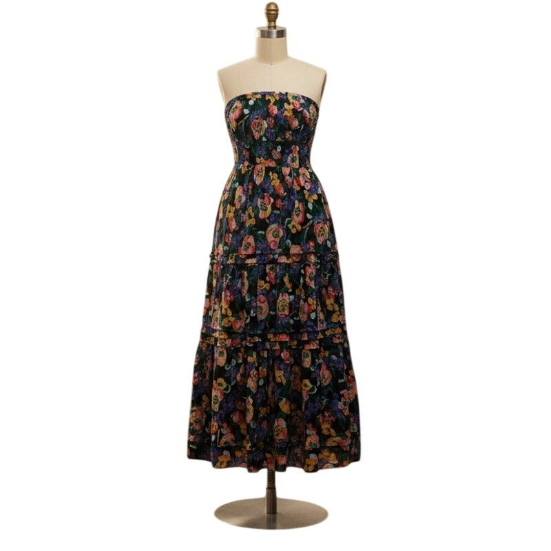 Strapless tiered maxi dress on mannequin with colorful floral print, ruffled skirt layers