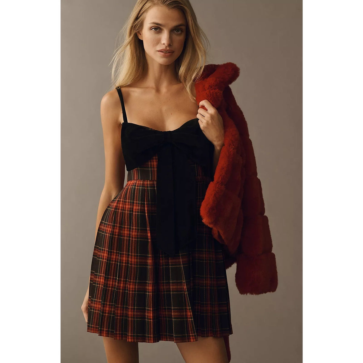 Plaid mini dress with black bodice, spaghetti straps, and bow-front neckline