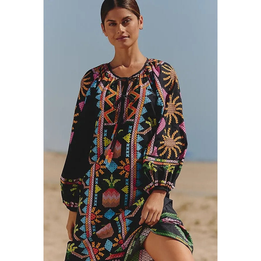 Black long-sleeve tie-front maxi dress with colorful geometric print and gathered neckline