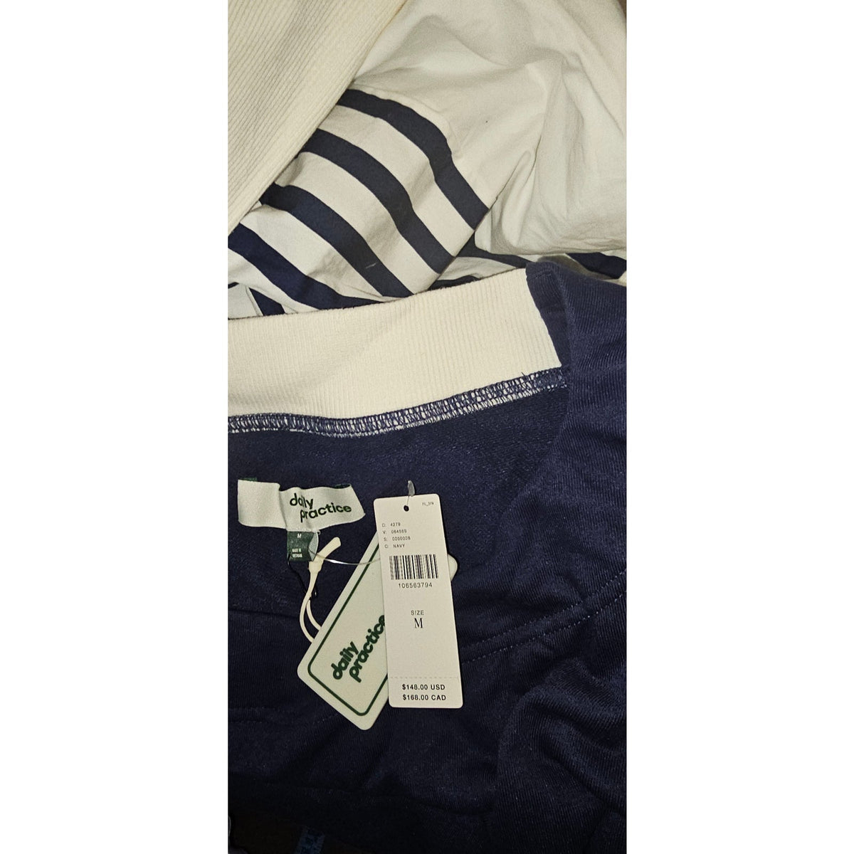 Navy and white striped fabric close-up with product hang tag and size label