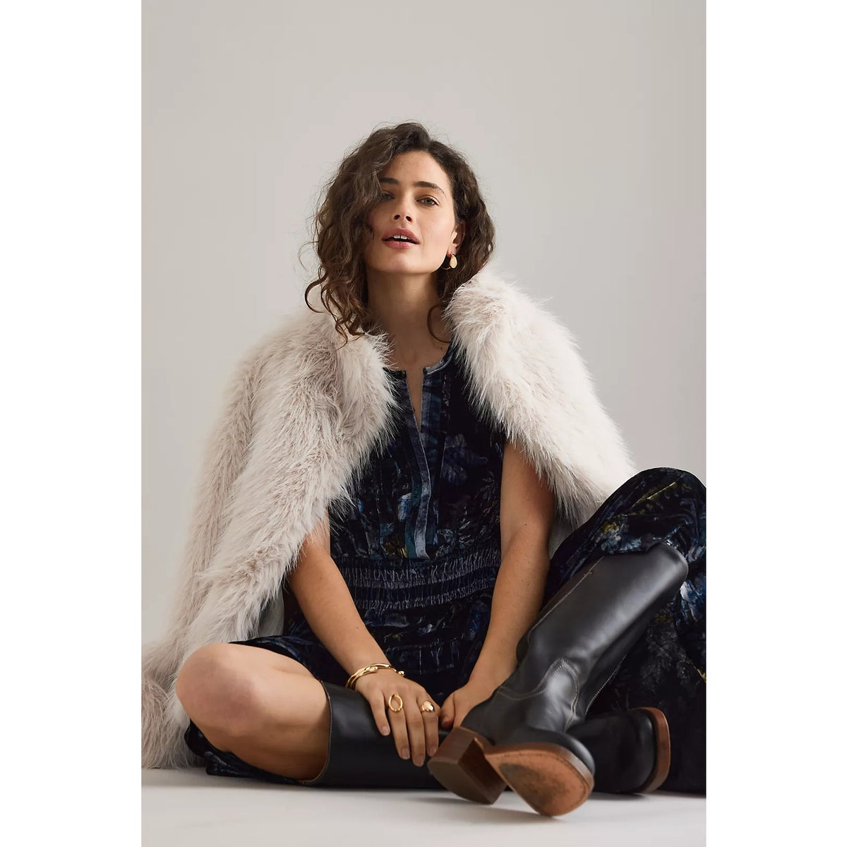 Dark blue velvet maxi dress with V-neck and tiered skirt, shown with ankle boots