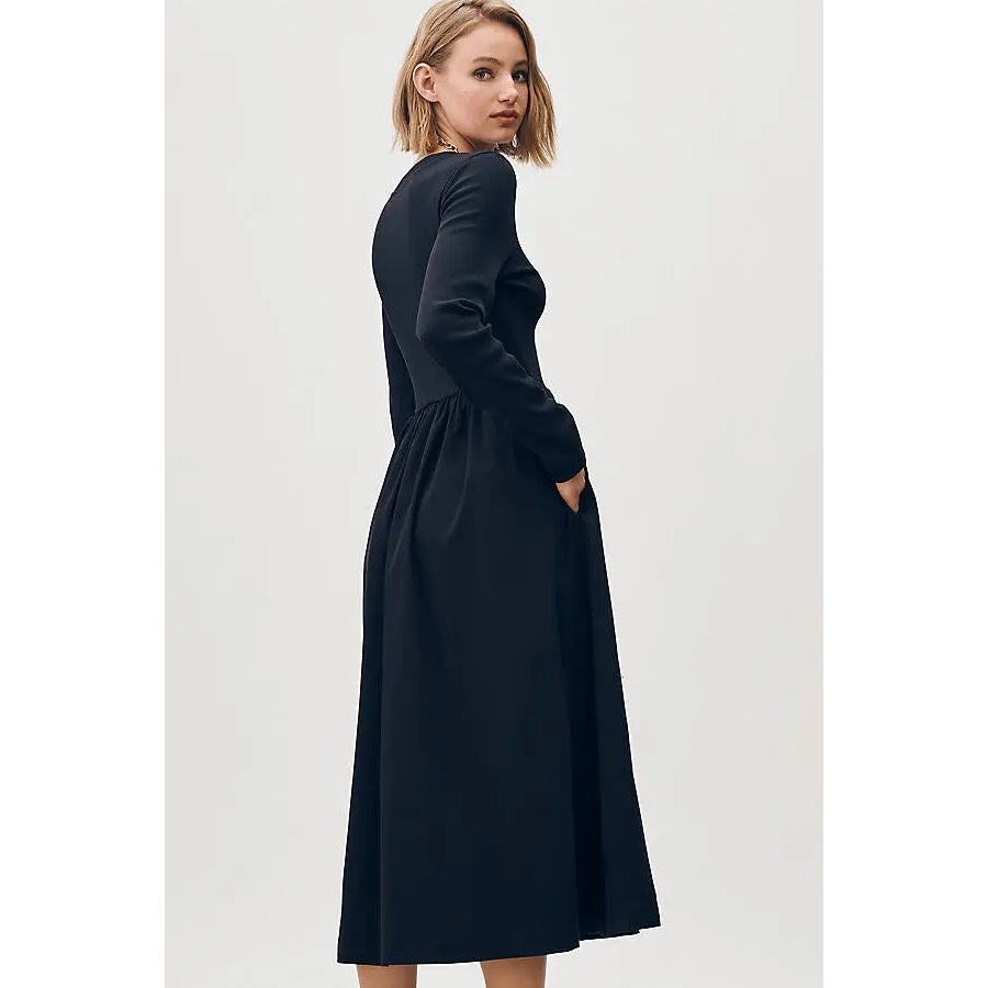 Black long-sleeve midi dress with buttoned bodice and gathered waist, side view