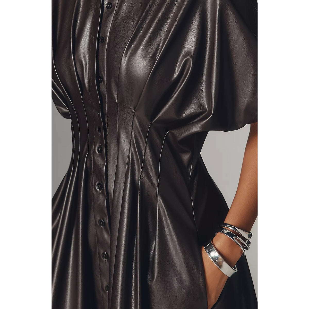 Faux leather mini shirt dress detail: button placket, short sleeves, and dark metallic finish