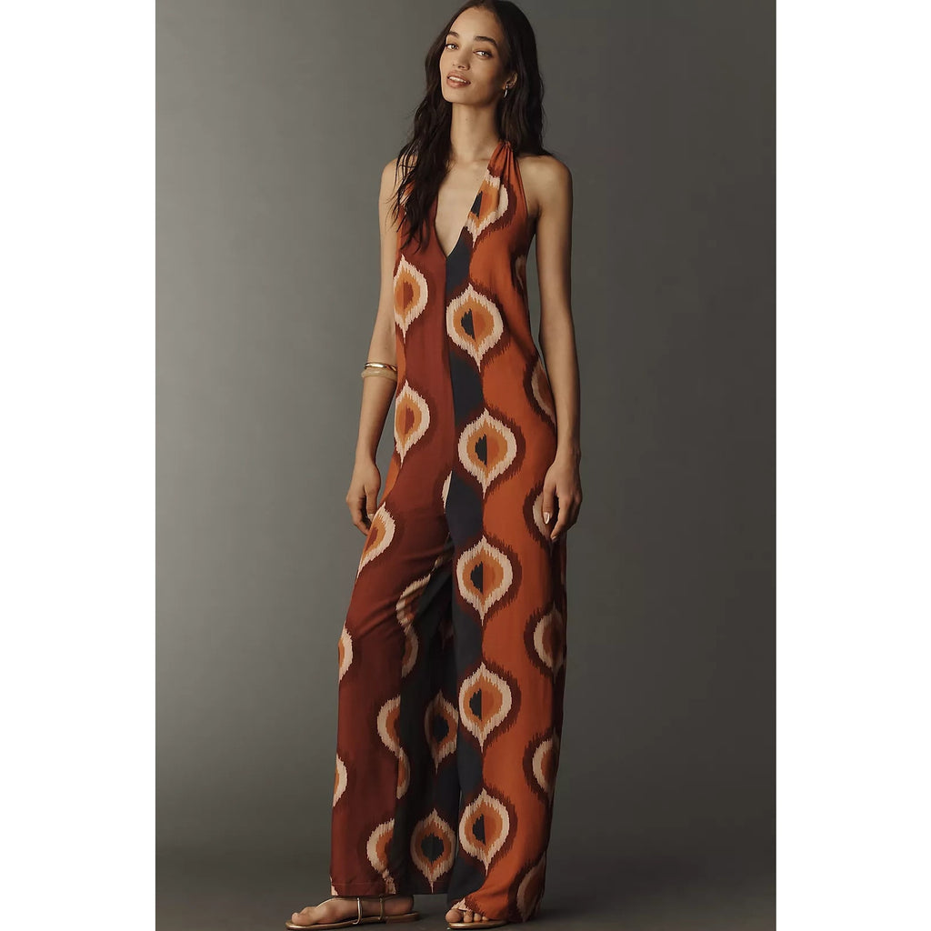 Brown halter-neck jumpsuit with bold cream and orange diamond pattern