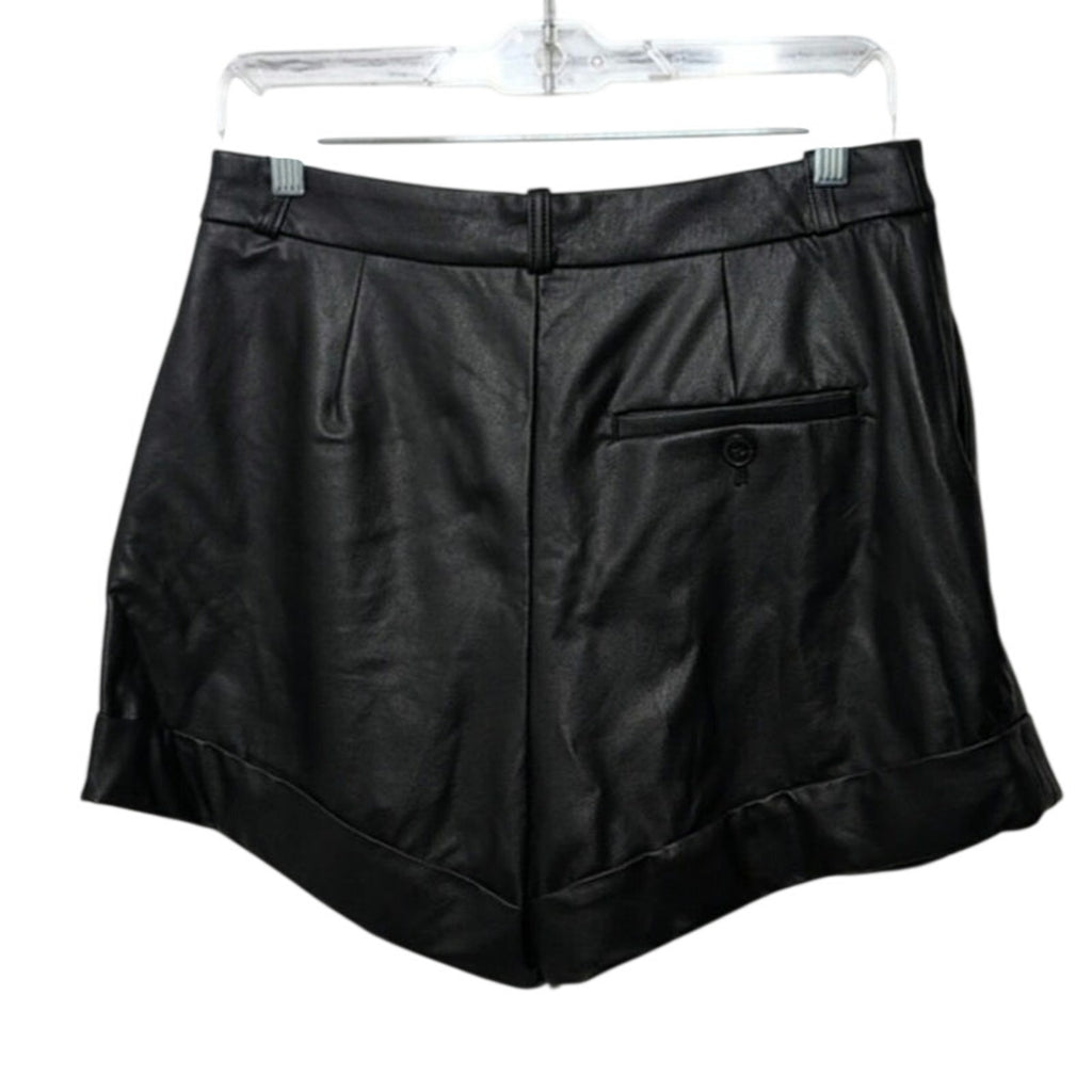 Black faux leather cuffed shorts with back welt pocket and stitched panels