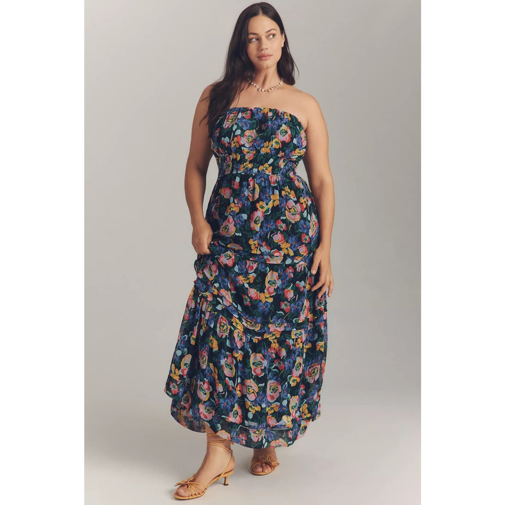 Strapless tiered maxi dress in dark blue with vibrant floral print and tiered layers