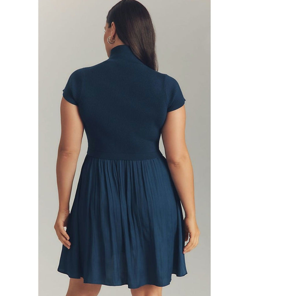 Dark navy knit mini dress with high back neck and gathered pleats on skirt