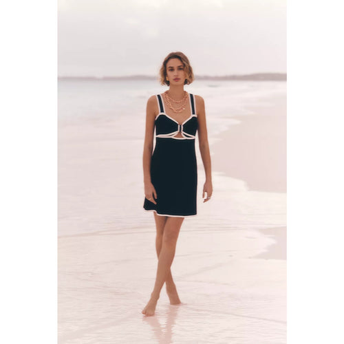 Black knit mini sweater dress with white trim and central bow cutout detail