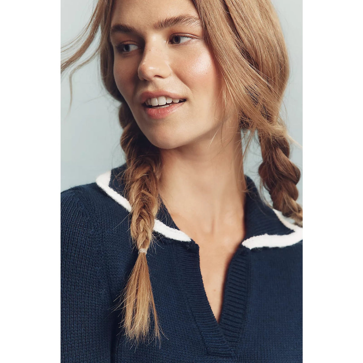 Navy knit mini dress close-up showing its V-neck polo collar with white trim