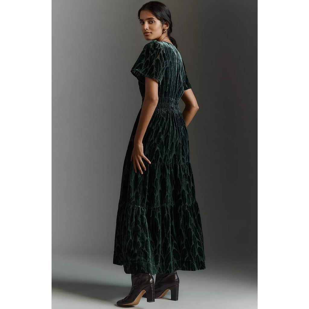 Dark teal velvet maxi dress side view with flutter sleeves and gathered skirt