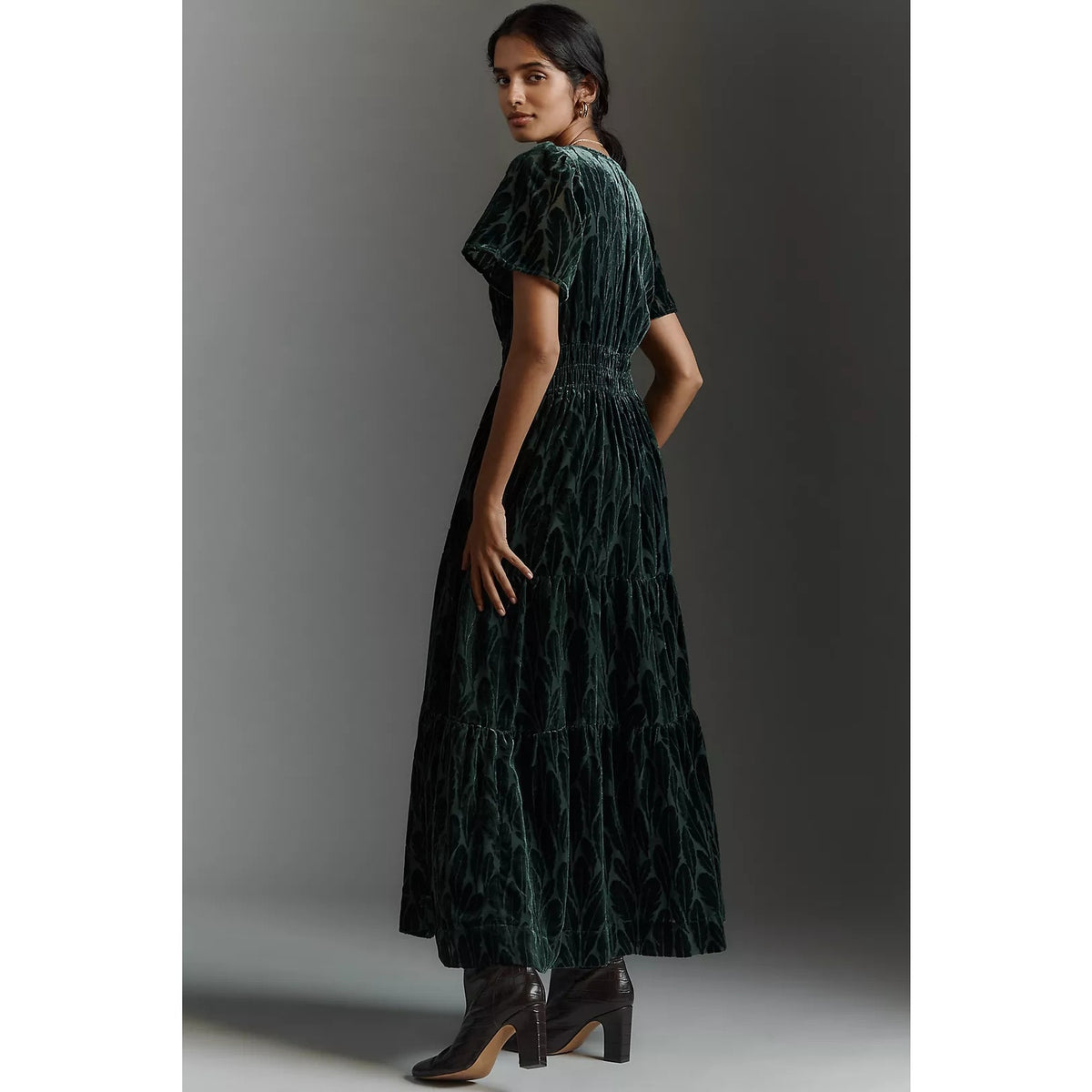 Dark teal velvet maxi dress side view with flutter sleeves and gathered skirt