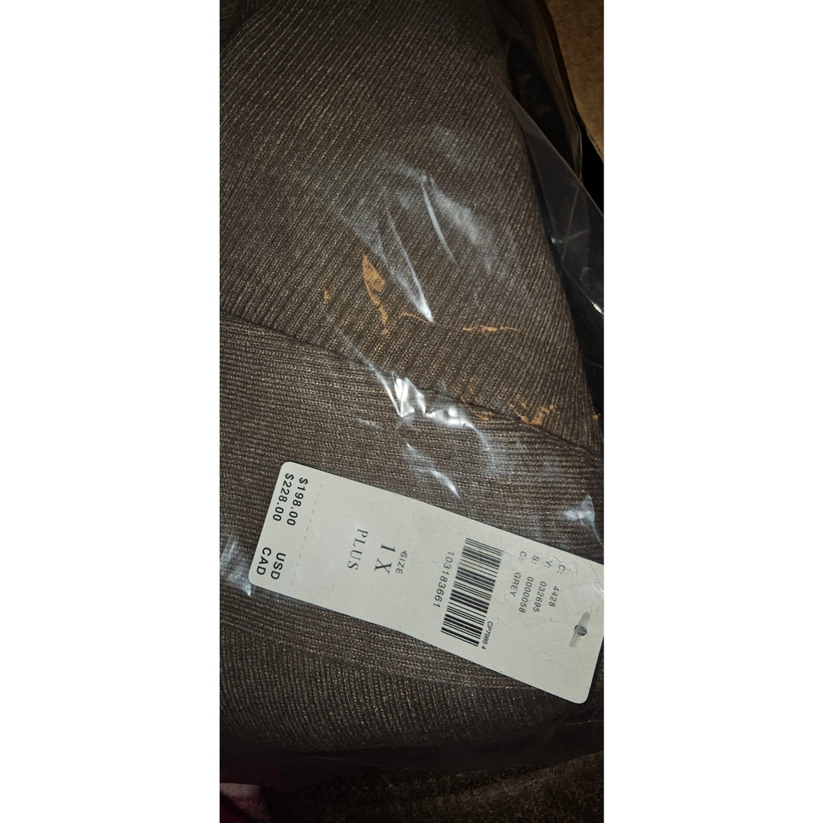 Heathered knit sweater dress fabric closeup with size tag